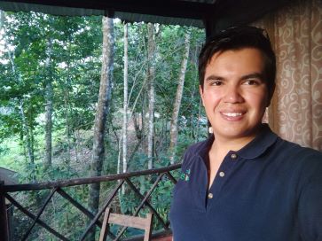 Description = Rodrigo Muñoz performing fieldwork in the Lacandona rainforest, Mexico.